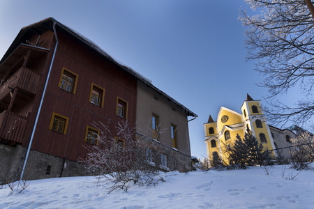Church of Assumption in snowy mountains country, Neratov, Orlicke horyの写真素材
