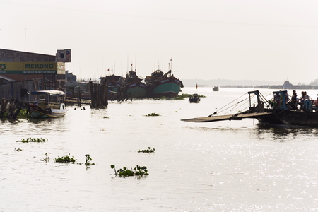 MY THO, VIETNAM - FEBRUARY 13: People crossing Mekong river on ferry on February 13, 2012 in My Tho, Vietnam.のeditorial素材