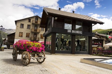 LIVIGNO, ITALY - AUGUST 1: Wain with flowers in front of fashion shops on streets of duty-free area on 1 August 2016 in Livigno, Italy.のeditorial素材
