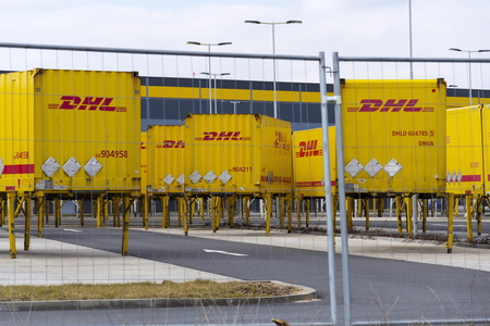 DOBROVIZ, CZECH REPUBLIC - MARCH 12: DHL shipping containers in front of Amazon logistics building...