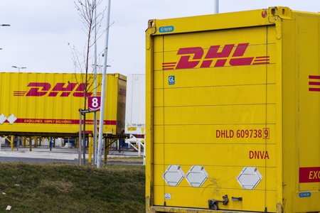 DOBROVIZ, CZECH REPUBLIC - MARCH 12: DHL shipping containers in front of Amazon logistics building...