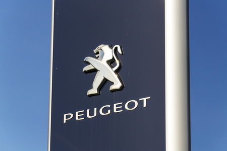 PRAGUE, CZECH REPUBLIC - MARCH 31: Peugeot car company logo in front of dealership building on March 31, 2017 in Prague, Czech republic. PSA agreed to buy Opel and its Vauxhall UK division.のeditorial素材
