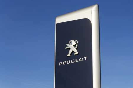 PRAGUE, CZECH REPUBLIC - MARCH 31: Peugeot car company logo in front of dealership building on March 31, 2017 in Prague, Czech republic. PSA agreed to buy Opel and its Vauxhall UK division.のeditorial素材