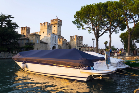 SIRMIONE, ITALY - JULY 30: Boats floating in front of Scaliger Castle on 30 July 2016 in Sirmione, Italy.のeditorial素材