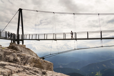RAMSAU AM DACHSTEIN, AUSTRIA - AUGUST 17: Tourists walk on the Austrias highest suspension bridge Dachstein Suspension bridge on August 17, 2017 in Ramsau am Dachstein, Austria.のeditorial素材