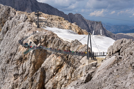 RAMSAU AM DACHSTEIN, AUSTRIA - AUGUST 17: Tourists walk on the Austrias highest suspension bridge Dachstein Suspension bridge on August 17, 2017 in Ramsau am Dachstein, Austria.のeditorial素材