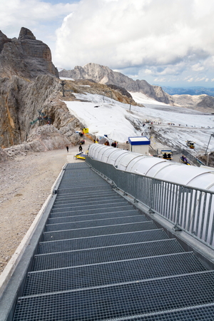 RAMSAU AM DACHSTEIN, AUSTRIA - AUGUST 17: Ski lift with people walking to Dachstein glacier on August 17, 2017 in Ramsau am Dachstein, Austria.のeditorial素材