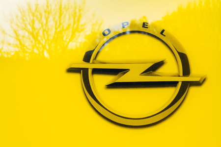 PRAGUE, CZECH REPUBLIC - NOVEMBER 5: Opel company logo on car in front of dealership building on November 5, 2017 in Prague. PSA Group plans to cut the number of models and rein in discounts at its Opel division.のeditorial素材