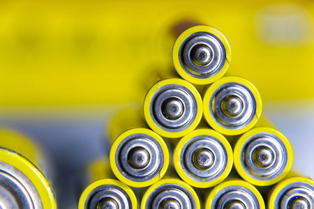 Stack of yellow AA batteries close up abstract color backgroundの写真素材