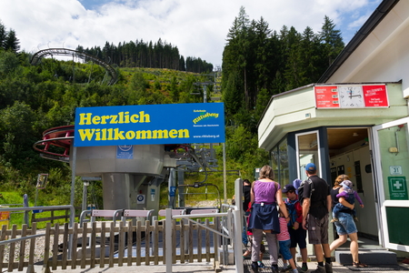 RAMSAU AM DACHSTEIN, AUSTRIA - AUGUST 17: People in front of bobsled roller coaster toboggan in Rittisberg amusement park on August 17, 2017 in Ramsau am Dachstein, Austria.のeditorial素材