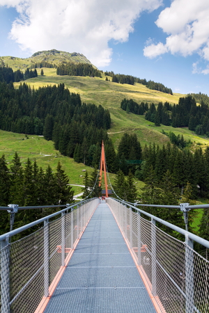 Alpine Golden Gate suspension bridge in Saalbach-Hinterglemm valley, Alps, Austriaの写真素材