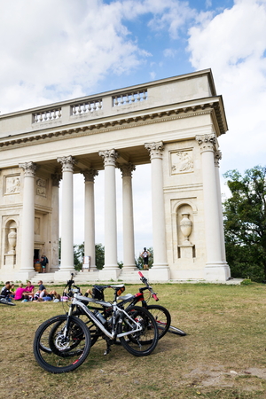 VALTICE, CZECH REPUBLIC - AUGUST 8: People with bikes in front of Colonnade Reistna classicist gloriette in Lednice Valtice cultural landscape area, UNESCO heritage site on August 8, 2017 in Valtice, Czech Republic.のeditorial素材