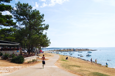 PREMANTURA, CROATIA - JULY 28: Tourists, caravans and boats by the Adriatic sea on July 28, 2016 in Premantura, Croatia.のeditorial素材