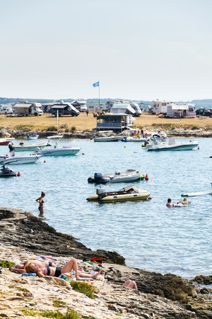 PREMANTURA, CROATIA - JULY 28: Tourists, caravans and boats by the Adriatic sea on July 28, 2016 in Premantura, Croatia.のeditorial素材