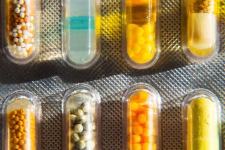 Colorful pills medicine capsule in transparent medicine capsule, illness concept