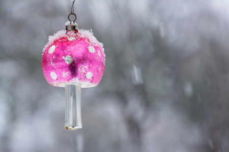 Fly agaric Christmas tree vintage glass decoration, falling snow landscape の写真素材
