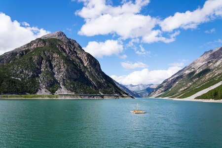 Pier with benches, Livigno lake with Corno Brusadella Mountain, Italyの写真素材