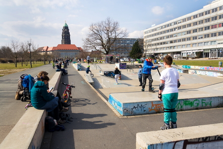 DRESDEN, GERMANY - APRIL 1 2018: People in Lingneralle skatepark with City Hall in background on April 1, 2018 in Dresden, Germany.のeditorial素材