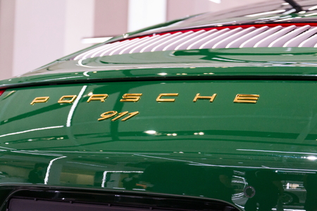 BERLIN, GERMANY - APRIL 15 2018: Porsche 911 Carrera S green car standing at Volkswagen Group forum...