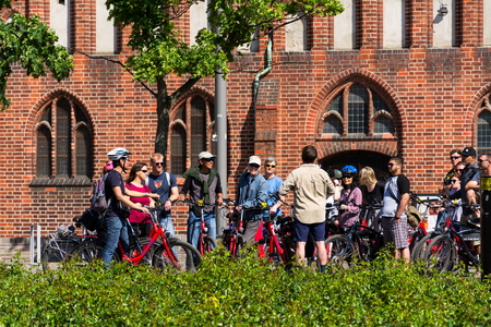 BERLIN, GERMANY - MAY 15 2018: Tourists on city bike tour standing in front of evangelic St. Marys Church, Marienkirche on May 15, 2018 in Berlin, Germany.のeditorial素材