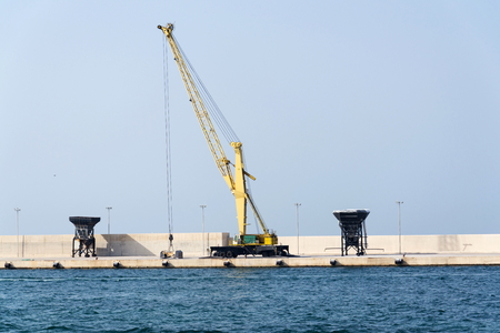 Empty shipping harbor with crane, freight digitalization, transportation efficiency conceptの写真素材