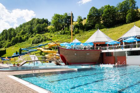 SAALBACH, AUSTRIA - JUNE 20 2018: People swimming in beautiful pool near Schattberg X-press cable car station in Saalbach on June 20, 2018 in Saalbach, Austria.のeditorial素材