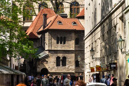 PRAGUE, CZECH REPUBLIC - APRIL 21 2018: People walk in front of the Klausen Synagogue, largest in former Prague Jewish ghetto, neighbouring with the Old Jewish Cemetery on April 21, 2018 in Prague, Czech Republic.のeditorial素材