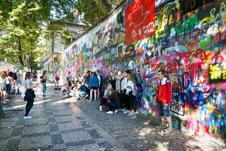 PRAGUE, CZECH REPUBLIC - SEPTEMBER 20 2018: People in front of public graffiti Lennon Wall near Charles Bridge, Mala Strana on September 20, 2018 in Prague, Czech Republic.のeditorial素材