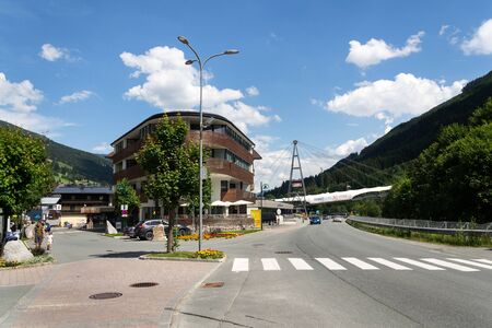 SAALBACH-HINTERGLEMM, AUSTRIA - JUNE 22 2018: People in front of Schattberg X-Press cable car over X-line bikers trail on June 22, 2018 in Saalbach-Hinterglemm, Austria.のeditorial素材