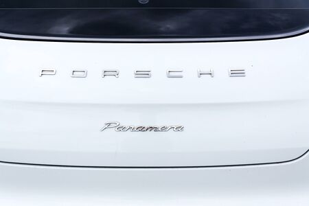 PRAGUE, CZECH REPUBLIC - SEPTEMBER 22 2018: Porsche Panamera logo on car in front of dealership building on September 22, 2018 in Prague, Czech Republic.のeditorial素材