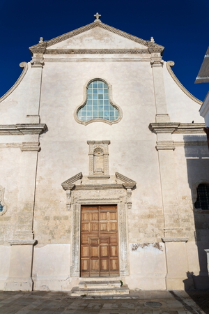 Seafront with catholic Church Chiesa San Salvatore in Monopoli, Adriatic sea, Italy, sunny summer dayの写真素材