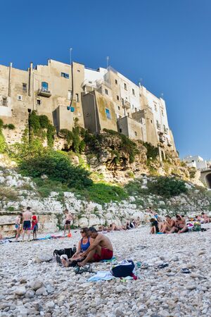POLIGNANO A MARE, ITALY - JULY 6 2018: People on lovely beach Lama Monachile, Adriatic Sea, Apulia, Bari province on July 6, 2018 in Polignano a Mare, Italy..のeditorial素材