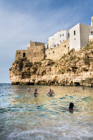 POLIGNANO A MARE, ITALY - JULY 6 2018: People on lovely beach Lama Monachile, Adriatic Sea, Apulia, Bari province on July 6, 2018 in Polignano a Mare, Italy..のeditorial素材