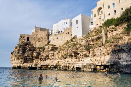 POLIGNANO A MARE, ITALY - JULY 6 2018: People on lovely beach Lama Monachile, Adriatic Sea, Apulia, Bari province on July 6, 2018 in Polignano a Mare, Italy..のeditorial素材