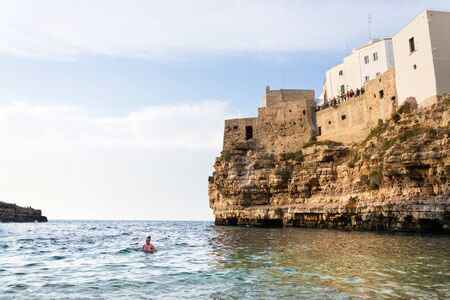 POLIGNANO A MARE, ITALY - JULY 6 2018: People on lovely beach Lama Monachile, Adriatic Sea, Apulia, Bari province on July 6, 2018 in Polignano a Mare, Italy..のeditorial素材