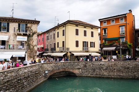 SIRMIONE, ITALY - JULY 31 2016: Tourists walking on colorful streets on 31 July 2016 in Sirmione, Italy.のeditorial素材