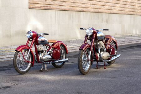 PRAGUE, CZECH REPUBLIC - MARCH 8 2018: Red vintage motorcycles Jawa 125 and Jawa 500 produced in former Czechoslovakia stand on road on March 8, 2018 in Prague, Czech Republic.のeditorial素材