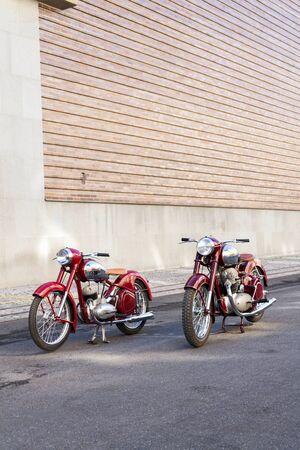 PRAGUE, CZECH REPUBLIC - MARCH 8 2018: Red vintage motorcycles Jawa 125 and Jawa 500 produced in former Czechoslovakia stand on road on March 8, 2018 in Prague, Czech Republic.のeditorial素材