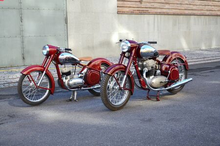 PRAGUE, CZECH REPUBLIC - MARCH 8 2018: Red vintage motorcycles Jawa 125 and Jawa 500 produced in former Czechoslovakia stand on road on March 8, 2018 in Prague, Czech Republic.のeditorial素材