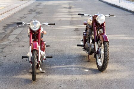 PRAGUE, CZECH REPUBLIC - MARCH 8 2018: Red vintage motorcycles Jawa 125 and Jawa 500 produced in former Czechoslovakia stand on road on March 8, 2018 in Prague, Czech Republic.のeditorial素材