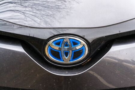 PRAGUE, CZECH REPUBLIC - NOVEMBER 23 2018: Toyota hybrid motor company logo on standing car on November 23, 2018 in Prague, Czech Republic.のeditorial素材
