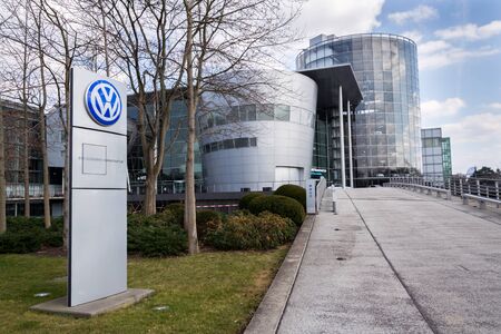 DRESDEN, GERMANY - APRIL 2 2018: Volkswagen company logo in front of the Glaserne Manufaktur -...
