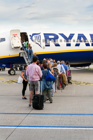 MEMMINGEN, GERMANY - JULY 6 2019: People boarding Ryanair Irish low-cost airline plane Boeing 737 with cloudy sky background on July 6, 2019 in Memmingen, Germany.のeditorial素材