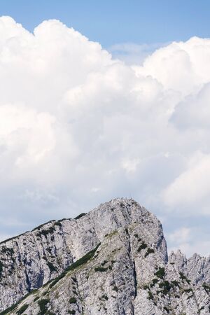 Unrecognizable people on top of the Grosser Donnerkogel Mountain in Alps,の写真素材