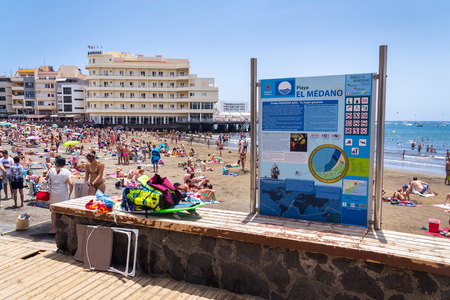 EL MEDANO, SPAIN - JULY 7 2019: People swimming and sunbathing on Playa El Medano beach on July 7, 2019 in El Medano, Spain.のeditorial素材