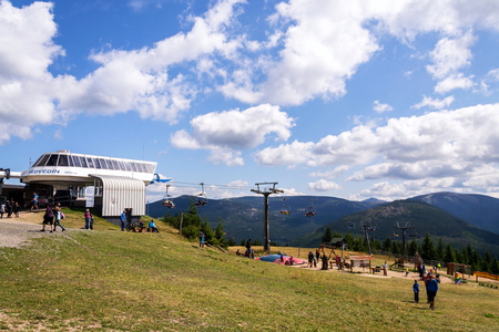 SPINDLERUV MLYN, CZECH REPUBLIC - AUGUST 15 2019: People walk around Medvedin mountain chairlift top...