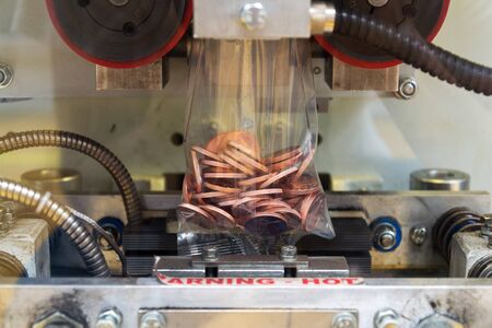Coins manufactured and packed in money mint machine, steel galvanized with copperの写真素材