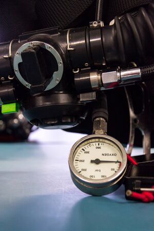 Gas pressure indicator, scuba diving oxygen lying on blue table background, copy spaceの写真素材