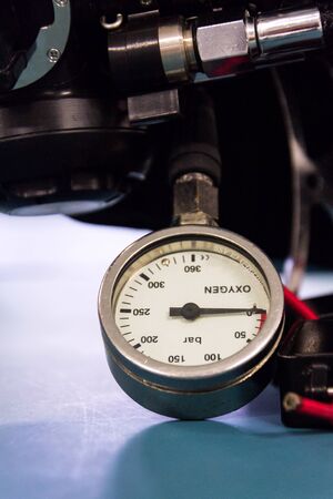 Gas pressure indicator, scuba diving oxygen lying on blue table background, copy spaceの写真素材