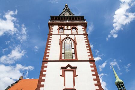 Sightseeing tower of the late gothic decanal Church of the Assumption of the Virgin Mary in Chomutov, Usti nad Labem region, Krusne hory, Ore Mountains, Czech Republic, sunny summer day, clear blue sky backgroundの写真素材